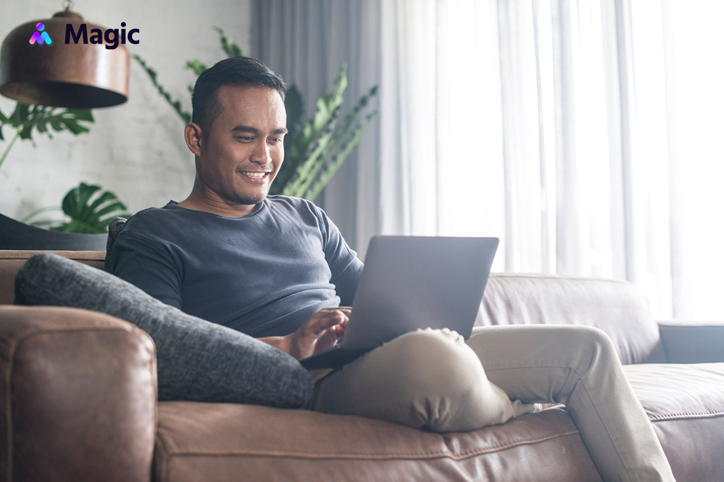 Happy business owner using his laptop